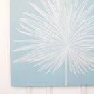 White palm leaf design on a light blue background