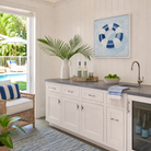Coastal Serena & Lily inspired interior featuring the "License To Chill" original pool float painting above a built-in bar.