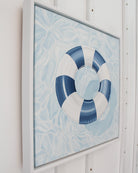 Side view of the original "License To Chill" coastal oil painting in a white wood floating frame by Laurie Duncan.