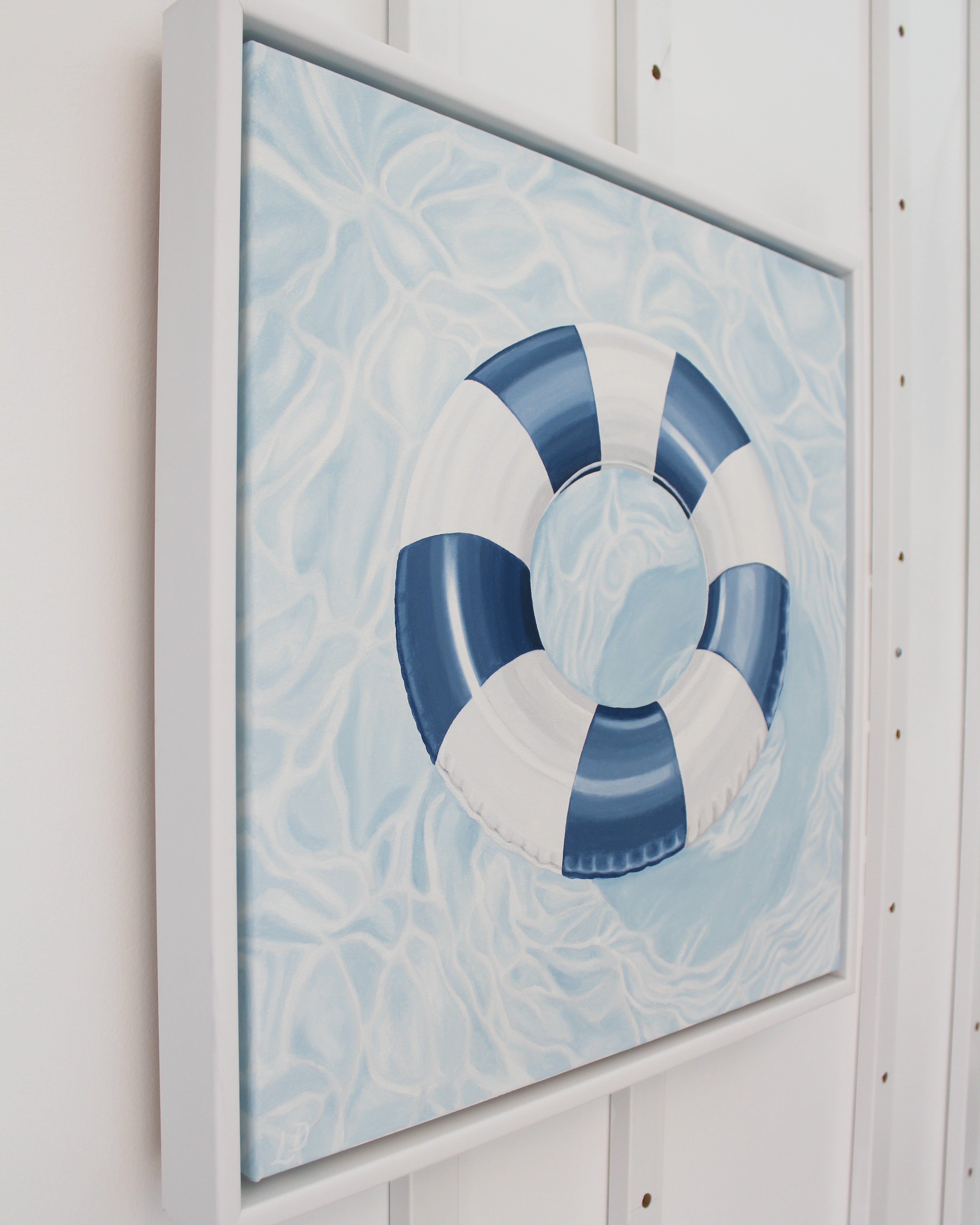Side view of the original "License To Chill" coastal oil painting in a white wood floating frame by Laurie Duncan.