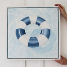"License To Chill" original oil painting featuring a blue and white pool float on sparkling water in a white float frame.