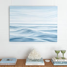 Calming Seas original coastal oil painting displayed above a sofa in a light coastal living room.